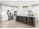 Spacious kitchen with white cabinetry, stainless steel appliances, a center island, and four bar stools at 1032 Country Pasture Cv, Wendell, NC 27591
