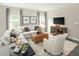 Bright living room features neutral tones, stylish furnishings, and ample natural light at 1032 Country Pasture Cv, Wendell, NC 27591