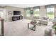 Spacious living room offers comfortable seating, entertainment center, and bright windows at 1032 Country Pasture Cv, Wendell, NC 27591