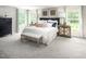 Stunning main bedroom boasts chic decor, plush bedding, and ample natural light at 1032 Country Pasture Cv, Wendell, NC 27591