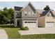 Charming two-story home with gray siding, a white garage door, and a well-maintained lawn at 1032 Harper Rd, Raleigh, NC 27603