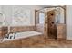 Luxurious bathroom featuring a soaking tub and glass-enclosed shower with decorative tiling and a decorative window at 105 Jessfield Pl, Cary, NC 27519