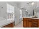 Bathroom featuring double sinks, granite countertop, and ample natural light at 105 Jessfield Pl, Cary, NC 27519