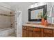Bathroom with granite countertops, wood cabinets, and shower over tub combination at 105 Jessfield Pl, Cary, NC 27519
