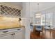 Charming dining area with light fixture, bar area, and plenty of natural light at 105 Jessfield Pl, Cary, NC 27519
