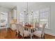 Elegant dining room features a modern chandelier, large windows and wood floors at 105 Jessfield Pl, Cary, NC 27519