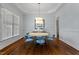 Dining room with beautiful wainscotting, hardwood floors, and a stylish light fixture at 105 Jessfield Pl, Cary, NC 27519