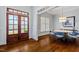 Elegant foyer featuring double doors, hardwood floors, and a charming dining area with ample natural light at 105 Jessfield Pl, Cary, NC 27519