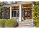 Inviting front porch with stone accents, wood ceiling, and a stylish double-door entryway at 105 Jessfield Pl, Cary, NC 27519