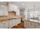 Well-appointed kitchen showcasing cabinetry, granite countertops, and tile backsplash at 105 Jessfield Pl, Cary, NC 27519