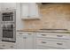 Kitchen features granite counters, double ovens and custom cabinets at 105 Jessfield Pl, Cary, NC 27519