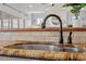 Close-up of a kitchen sink with granite countertops and tile backsplash at 105 Jessfield Pl, Cary, NC 27519