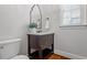 Stylish powder room features a vanity, mirror, and classic fixtures, offering convenience and charm at 105 Jessfield Pl, Cary, NC 27519