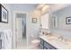 Bathroom with patterned floors, blue vanity, toilet, and view into another room at 105 Wicklow Pl, Chapel Hill, NC 27517