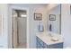 Well-lit bathroom features a blue vanity and a shower behind a white door at 105 Wicklow Pl, Chapel Hill, NC 27517
