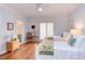 Bright bedroom featuring white bedding, hardwood floors, and ample natural light at 105 Wicklow Pl, Chapel Hill, NC 27517