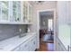 Butler pantry with tile backsplash and white cabinetry at 105 Wicklow Pl, Chapel Hill, NC 27517