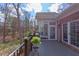Outdoor deck with wooded views, black railing, and brick exterior at 105 Wicklow Pl, Chapel Hill, NC 27517