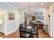 Charming dining area with hardwood floors, chandelier, and doorway to the living room at 105 Wicklow Pl, Chapel Hill, NC 27517