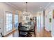 Bright dining area with hardwood floors, view of the kitchen and outdoor access at 105 Wicklow Pl, Chapel Hill, NC 27517
