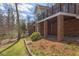 Brick house with two levels and a sunroom, and mature landscaping with trees, shrubs, and mulch at 105 Wicklow Pl, Chapel Hill, NC 27517