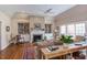 Bright living room featuring hardwood floors, fireplace, and custom bookshelves at 105 Wicklow Pl, Chapel Hill, NC 27517
