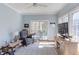 Cozy sitting room with natural light, ceiling fan, and access to outdoor patio at 105 Wicklow Pl, Chapel Hill, NC 27517