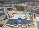 Aerial view of the community center, pool, tennis courts, bocce ball, and lake, highlighting amenities at 106 Ivory Ln, Raleigh, NC 27610