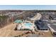 Aerial view of the community amenities, showing the pool, tennis courts, clubhouse and surrounding neighborhood at 106 Ivory Ln, Raleigh, NC 27610