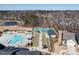 An aerial perspective showcases a community pool, tennis court, bocce ball and picturesque pond at 106 Ivory Ln, Raleigh, NC 27610