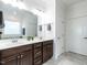 Bathroom with double sink vanity, dark brown cabinets, and a large mirror, offering a functional and stylish space at 106 Ivory Ln, Raleigh, NC 27610