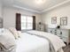 Bright and airy bedroom with a tray ceiling, soft bedding, neutral decor, and ample natural light at 106 Ivory Ln, Raleigh, NC 27610