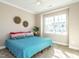 Bright and airy bedroom featuring a ceiling fan, a large window, and neutral colored walls at 106 Ivory Ln, Raleigh, NC 27610