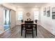 Elegant dining room with hardwood floors, a modern chandelier, and sliding glass doors to the outdoor living space at 106 Ivory Ln, Raleigh, NC 27610