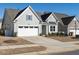 Traditional home featuring a white two-car garage, neutral siding, dark roof and well-kept landscaping at 106 Ivory Ln, Raleigh, NC 27610
