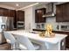 Modern kitchen with stainless steel appliances, dark wood cabinets, and white quartz countertops at 106 Ivory Ln, Raleigh, NC 27610