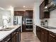 Spacious kitchen featuring stainless steel appliances, dark wood cabinets, and a breakfast bar at 106 Ivory Ln, Raleigh, NC 27610