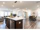 Bright, open-concept kitchen with a large center island, stainless appliances, and views of the dining and living areas at 106 Ivory Ln, Raleigh, NC 27610