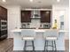 Stylish kitchen island with quartz countertops, modern lighting, and stainless-steel appliances at 106 Ivory Ln, Raleigh, NC 27610