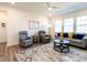 Charming living room with modern decor, comfortable seating, a patterned rug, and large windows for natural light at 106 Ivory Ln, Raleigh, NC 27610