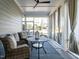 Relaxing screened porch with wicker chairs, a ceiling fan, and a view of the backyard at 106 Ivory Ln, Raleigh, NC 27610