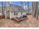 Backyard view highlighting the deck, adjacent home, and treed surroundings at 107 Fishers Creek Ct, Cary, NC 27513