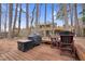 Cozy backyard deck with outdoor seating, BBQ grill, and wooded views, perfect for entertaining guests at 107 Fishers Creek Ct, Cary, NC 27513