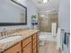 Bathroom features a large mirror, granite vanity, and sliding glass shower door at 107 Fishers Creek Ct, Cary, NC 27513