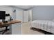 Bedroom with light blue walls, a single bed, and a desk in the room at 107 Fishers Creek Ct, Cary, NC 27513