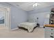 Bedroom with light blue walls, ceiling fan, and a single bed with patterned bedding at 107 Fishers Creek Ct, Cary, NC 27513