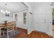 Dining room view with hardwood floors, chair rail, and a white door leading to the front porch at 107 Fishers Creek Ct, Cary, NC 27513
