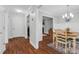 Elegant dining room with hardwood floors, chair rail molding, chandelier, and open access to the living room at 107 Fishers Creek Ct, Cary, NC 27513