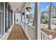 Cozy front porch featuring wood flooring, white railing, and a view of the neighborhood at 107 Fishers Creek Ct, Cary, NC 27513