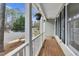 Charming front porch view with flowers and white railings, showing a glimpse of the quiet neighborhood at 107 Fishers Creek Ct, Cary, NC 27513